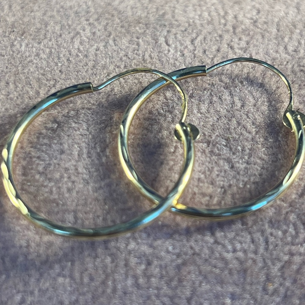 Pair of 14 kt gold hoop earrings.